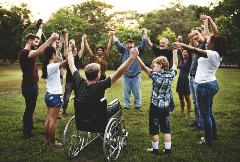 Adeo News & Articles Group of people holding hSupport Adeo and together in the park